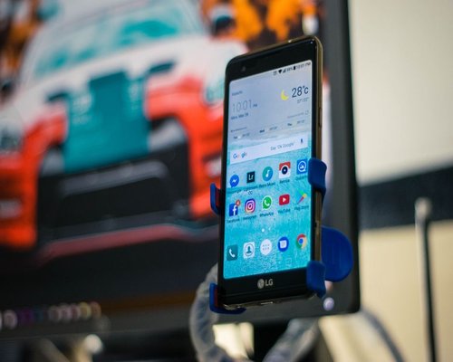 Secondary smartphone displaying a fictional mobile game interface during a technology exhibition